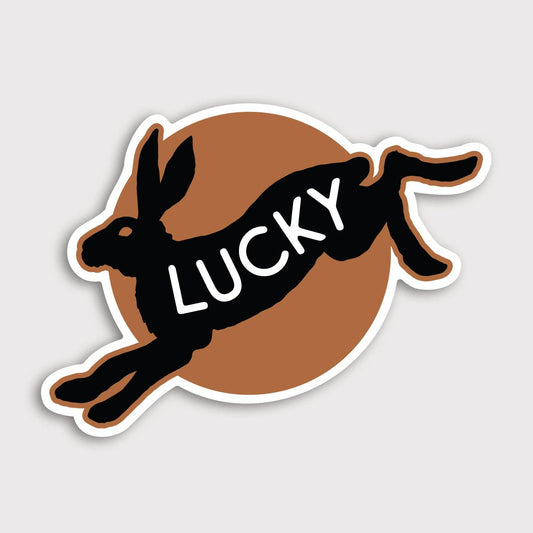 The Lucky sticker shows a black leaping rabbit over a brown circle with white script across its body.