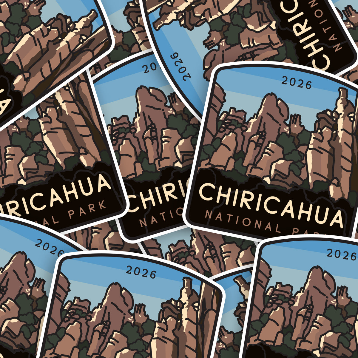 Dozens of Chiricahua National Park stickers overlap in a scattered pile, their hoodoo spires facing different directions.