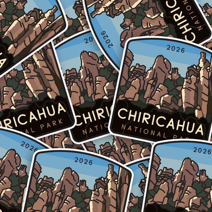 Dozens of Chiricahua National Park stickers overlap in a scattered pile, their hoodoo spires facing different directions.