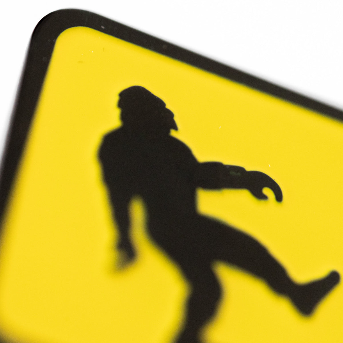 A close crop catches the striding silhouette on the Bigfoot Crossing pin with its edges softly blurred.