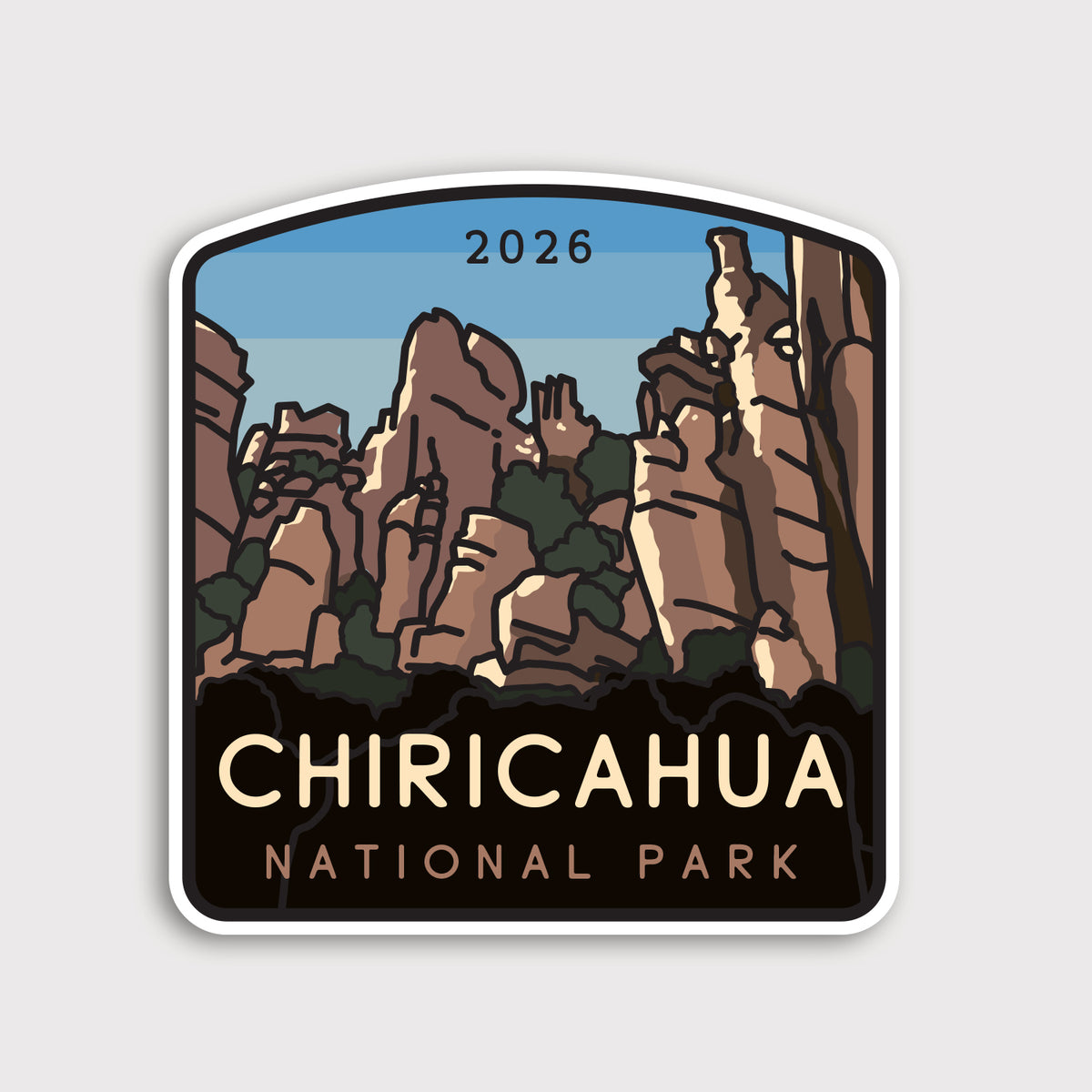 Rock spire towers rise in illustrated form on the Chiricahua National Park sticker, dated 2026 above the title.