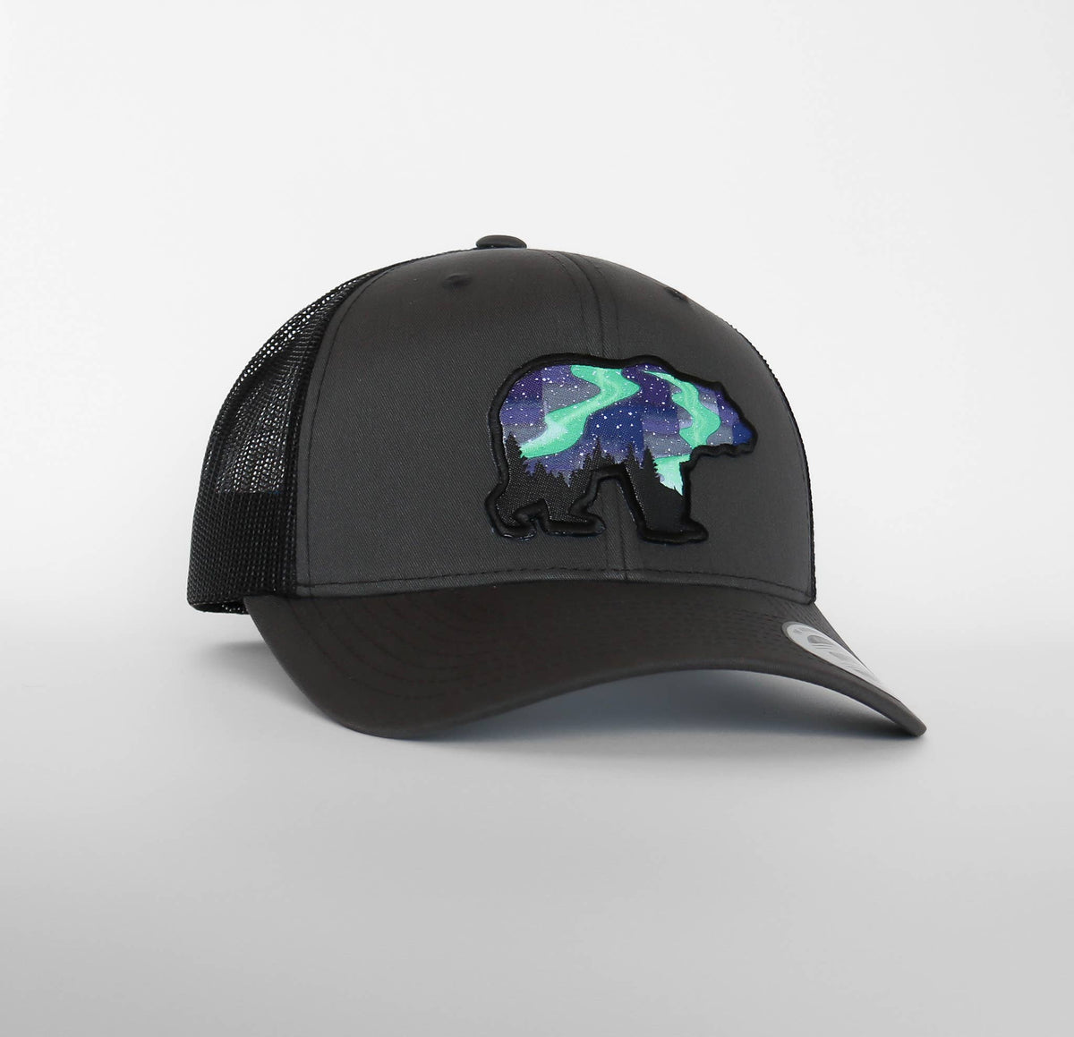 Charcoal front and black mesh meet on this Northern Lights Grizzly Bear trucker hat facing slightly left.