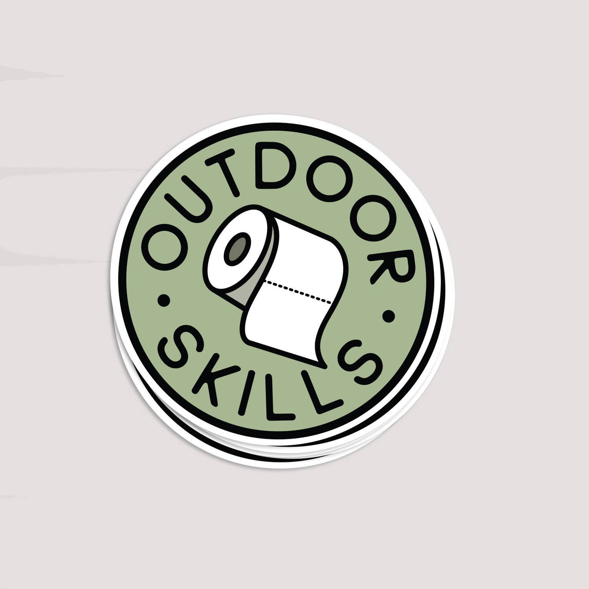 A short stack of Outdoor Skills stickers rests on a pale grey surface, top one facing up.
