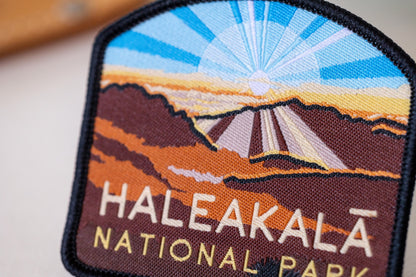 Close crop on the Haleakala National Park patch, where black merrow edging meets the orange crater walls.