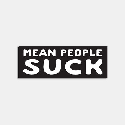 A single Mean People Suck sticker sits flat against a white backdrop, its bubble letters stark white on black.