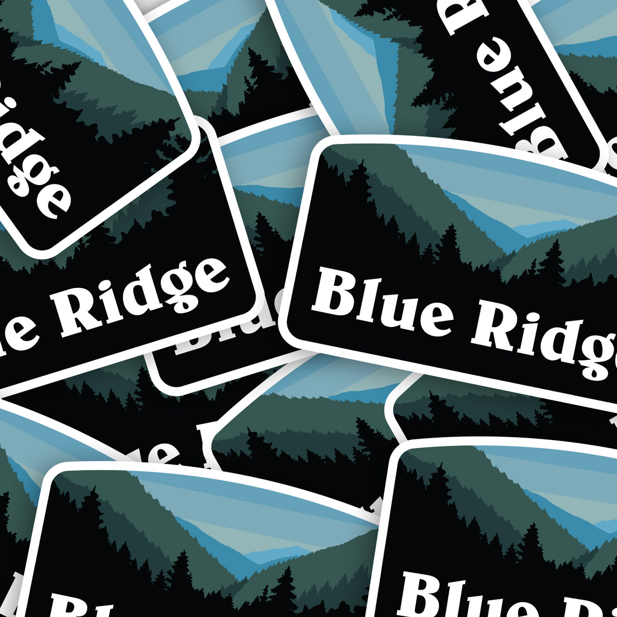 Overlapping Blue Ridge stickers scatter across the frame, their mountain art repeating in a loose pile.