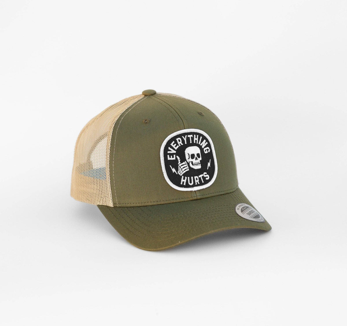 Olive and tan Everything Hurts trucker hat angled on white, its skull patch reading Everything Hurts in black and white.