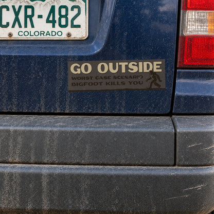 A blue SUV's rear panel holds the Go Outside Bigfoot Kills You sticker just under a Colorado license plate.