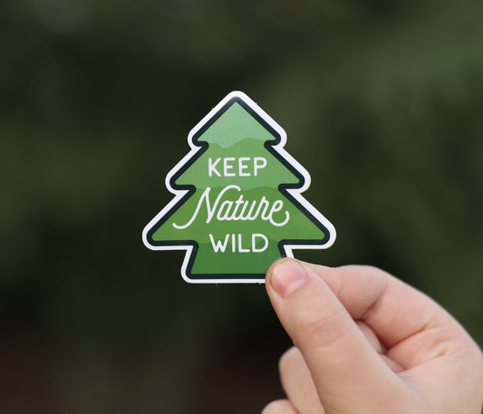Held a little further back, the Keep Nature Wild sticker shows its full pine tree outline and script lettering.